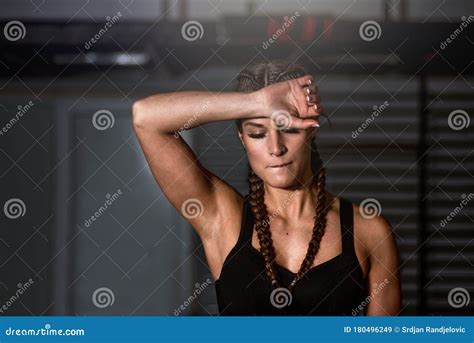 Young Sweaty Strong Muscular Fit Girl Hands Holding Heavy Kettlebell On The Floor Concentrating