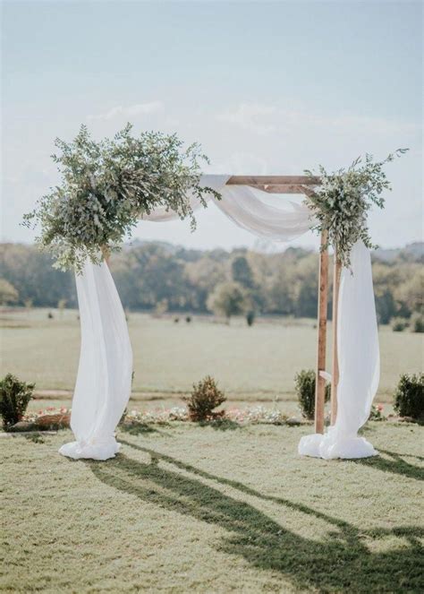 Olive And Eucalyptus Ceremony Arch With Ivory Voile Draping
