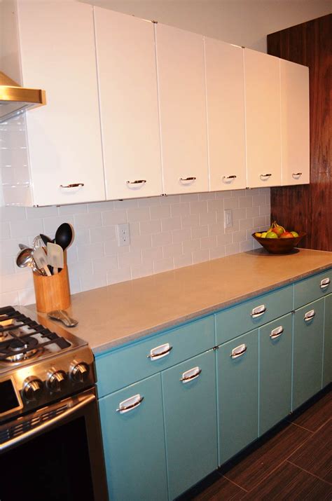Example of a cottage kitchen design in austin with white appliances, metal backsplash, metallic backsplash, gray cabinets, shaker cabinets and a farmhouse sink ok, look past the range hood. Sam has a great experience with powder coating her vintage ...