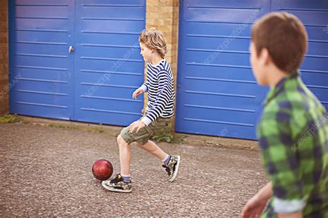Two Boys Playing Football By Garage Stock Image F0112597 Science