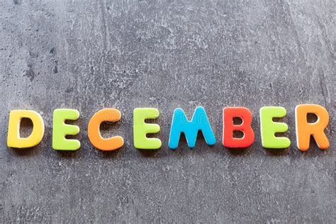 December Word Written With Colorful Letters On Wooden Background Stock