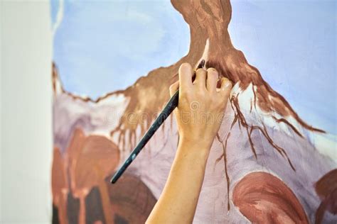 Girl Artist Hand Holds Paint Brush And Draws Abstract Surreal Landscape
