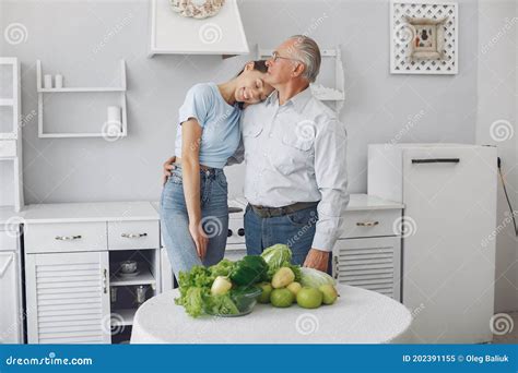 Old Man In A Kitchen With Young Granddaughter Stock Image Image Of