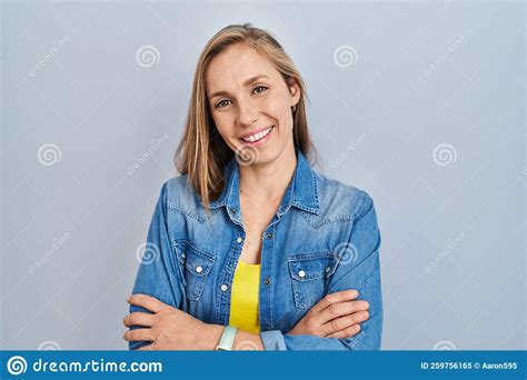 Young Blonde Woman Standing Over Blue Background Happy Face Smiling
