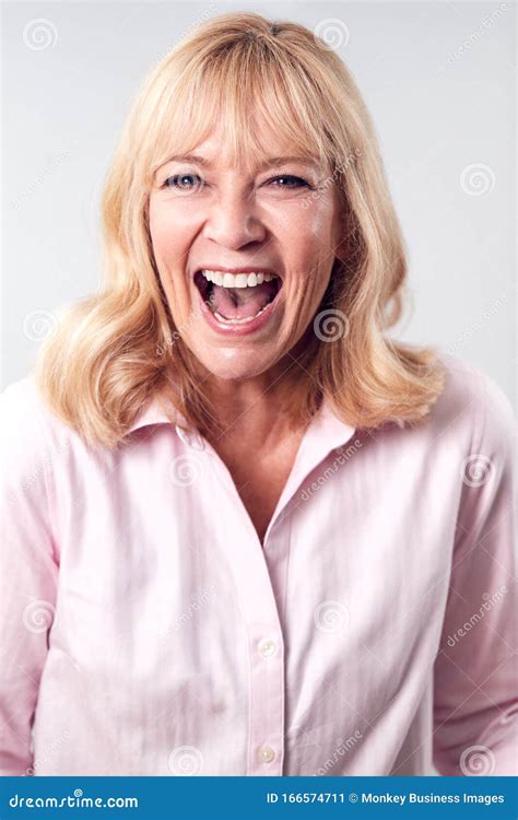 Studio Shot Of Laughing Mature Woman Against White Background At Camera Stock Image Image Of