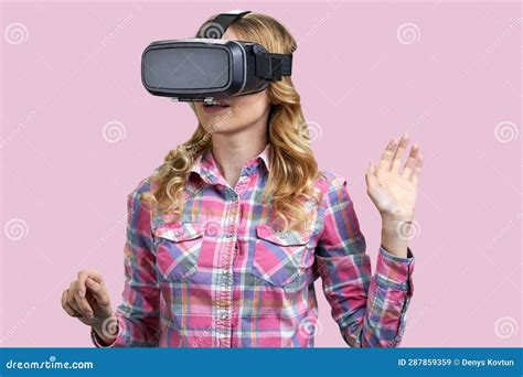 Portrait Of Young Blonde Experiencing Virtual Reality Simulation Stock