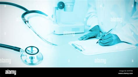 Metal Black Stethoscope Against Doctor Writing On Clipboard Stock Photo Alamy