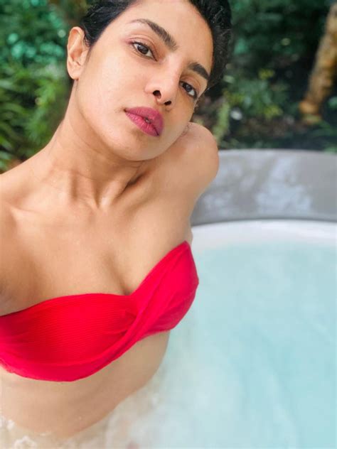 priyanka chopra sizzles in red bikini while enjoying some pool time bollywood news bollywood