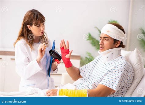 The Young Doctor Examining Injured Patient Stock Image Image Of