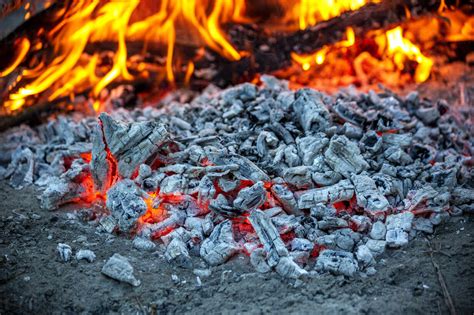 Embers Burning In Campfire Ash Stock Photo
