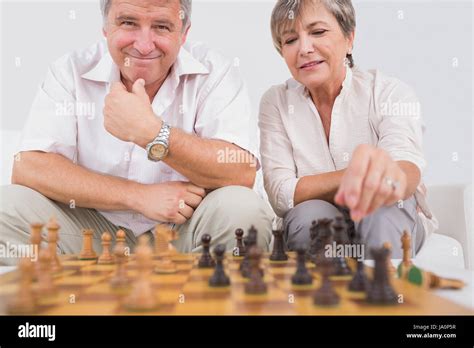 Old Couple Playing Chess In Sitting Room Stock Photo Alamy