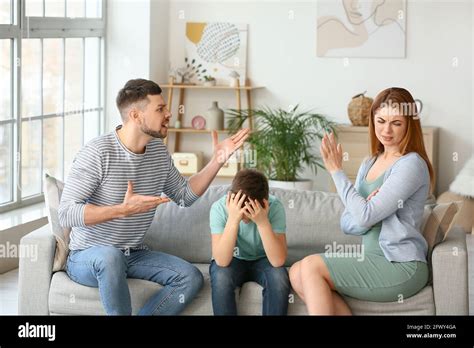 Sad Little Boy And His Quarrelling Parents At Home Stock Photo Alamy