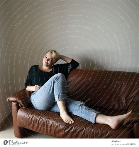 Junge Frau Sitzt Auf Der Couch Ein Lizenzfreies Stock Foto Von Photocase