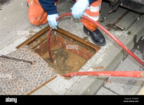 Dyno Rod Worker Drain Clearing Blocked Drain Outside A Terraced House
