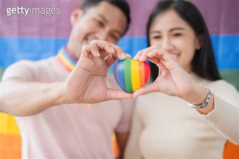 Men And Women Hold Rainbow Hearts A Symbol Of The Lgbt Community In Support Of Gender Equality