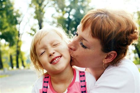 An Affectionate Mom Kissing Her Little Daughter Stock Image Image Of Friendly Kiss 56222489