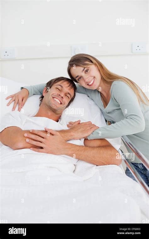 Smiling Couple Hugging Each Other On A Hospital Bed Stock Photo Alamy