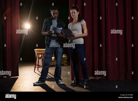 Actors Reading Their Scripts On Stage In Theatre Stock Photo Alamy