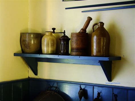 Glass open shelves on gold brackets display vintage dishes. Free Pioneer Images