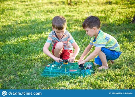 Two Boys Playing With A Spinning Top Kid Toy Popular Children Game