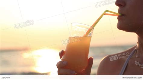 Woman Sipping A Refreshing Cocktail At Sunset Stock Video Footage 2242460