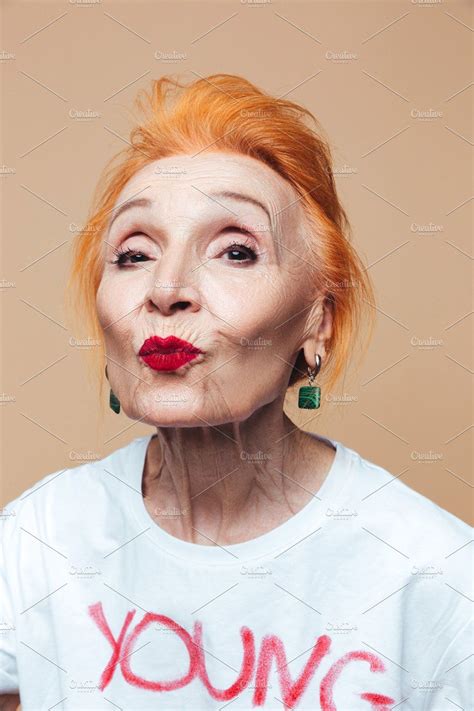 Mature Redhead Fashion Woman Blowing Kisses By Royalty Free Images On