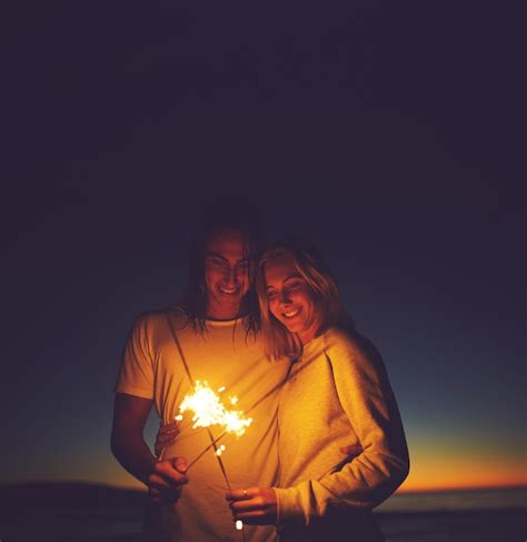 Premium Photo Lets Light Up The Night Shot Of A Young Couple Playing