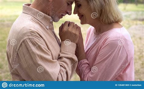 Happy Romantic Couple Holding Hands Smiling Grandparents