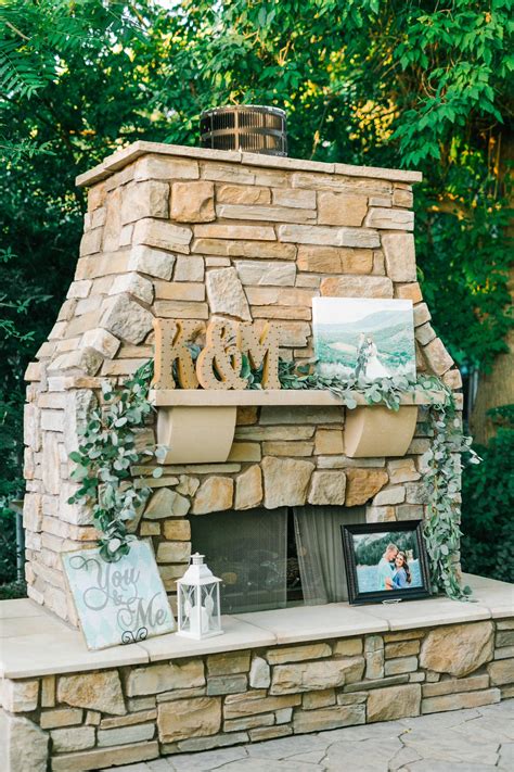 Perfect, cozy fireplace for an outdoor wedding. Eucalyptus garland