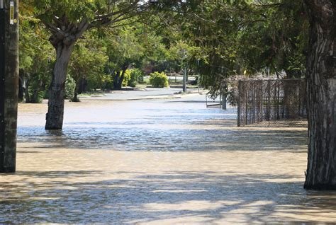 Flood meaning, definition, what is flood: Rocky flood photos from the ground - Rockhampton