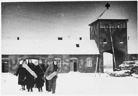 A group of female survivors of Auschwitz-Birkenau trudge through the snow through as they depart ...