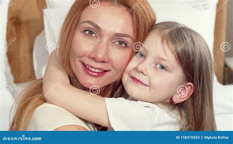 happy mother hugging her little daughter hugging smiling to the camera stock image image of