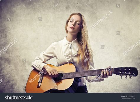 Beautiful Blonde Girl Playing Classic Guitar Stock Photo