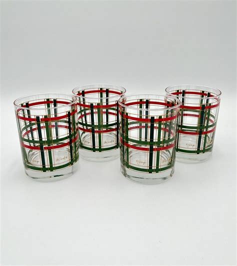 Four Glasses With Red Green And White Stripes On The Rims Are Lined Up