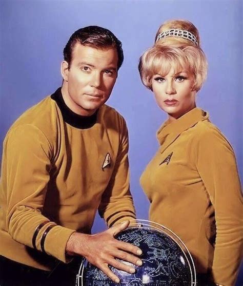 The Man And Woman Are Posing For A Photo With An Earth Globe In Front