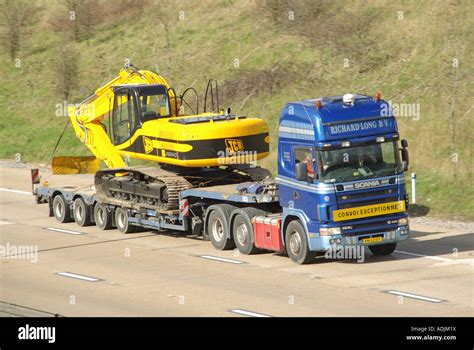 M25 Motorway Continental Registered Scania Lorry And Low Loader Stock