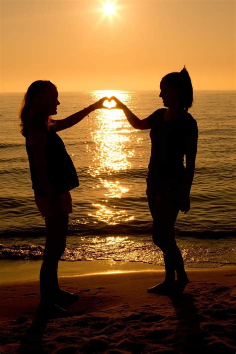Free Stock Photo Of Two Girls Making Heart With Sunset And Ocean