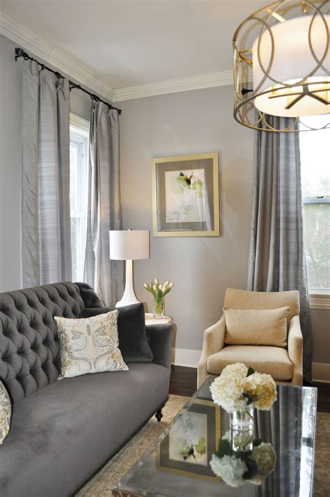 This living room is facing north so the designers chose a soft yellow for the ceiling to bring about warmth. gray traditional living room, elegant gray living room ...
