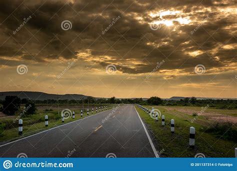 View Of The Highway And Beautiful Sun Rising Sky With Asphalt Highways