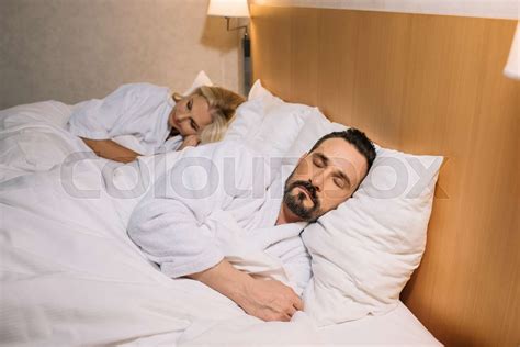 mature couple sleeping in hotel stock image colourbox
