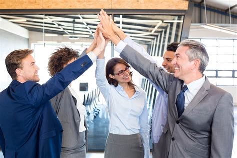 Premium Photo Happy Business Team High Fiving In Office