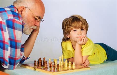 Grandfather And Grandson Playing Chess Grandpa Teaching His Grandchild