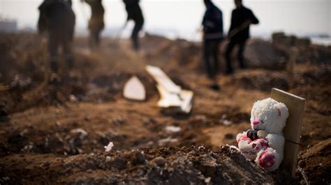 Families Forced To Bury Loved Ones In Mass Graves As Bodies Line The