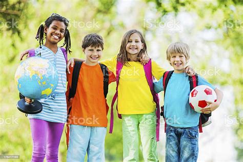 Embraced Cheerful School Kids In Park Stock Photo Download Image Now