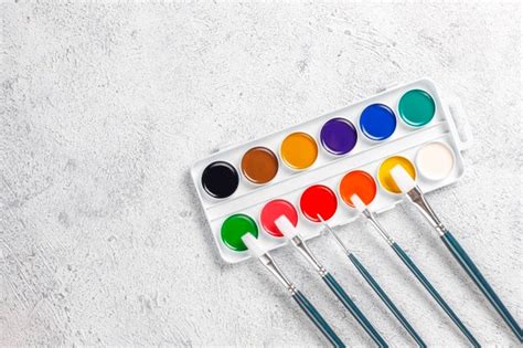 Free Photo Set Of Watercolor Paints And Paintbrushes For Painting