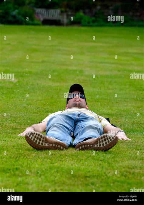 Man Laying Flat Out On A Lawn Stock Photo Alamy