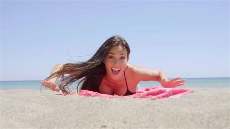 Excited Attractive Young Woman Lying On A Beach Stock Footage Videohive