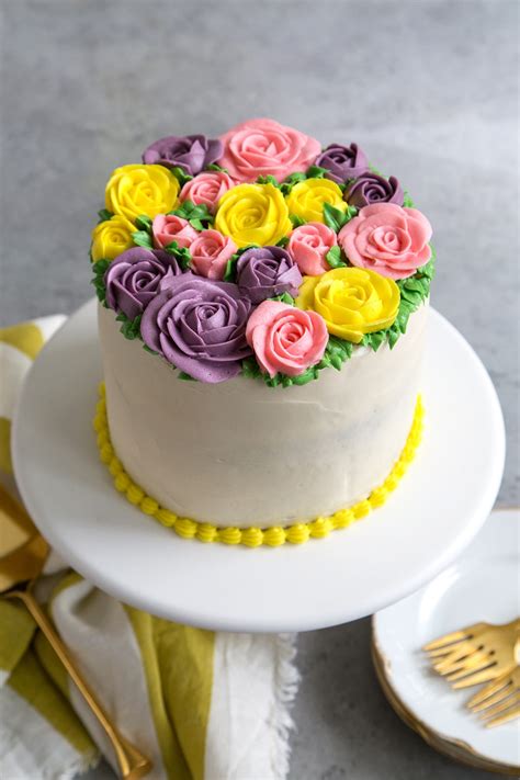 The cake is iced in vanilla buttercream. Buttercream Flowers Cake- The Little Epicurean