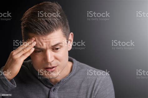 Portrait Of A Worried Young White Man Looking Down Stock Photo