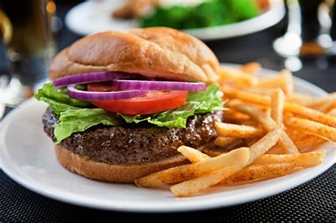 Chargrilled Burger Served With Lettuce Tomato And Red Onion On A